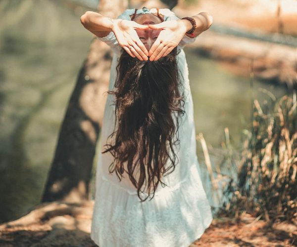 Person meditating peacefully in a calm, serene environment.
